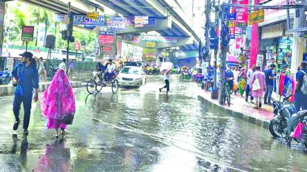 Residents struggle as rain floods Dhaka streets